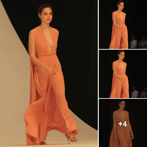 Gal Gadot: Exuding Radiant Confidence as She Struts the Catwalk in a Stunning Orange Ensemble.